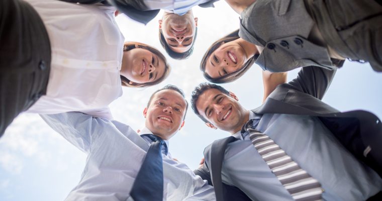 Successful group of business people hugging as a team - teamwork concepts
