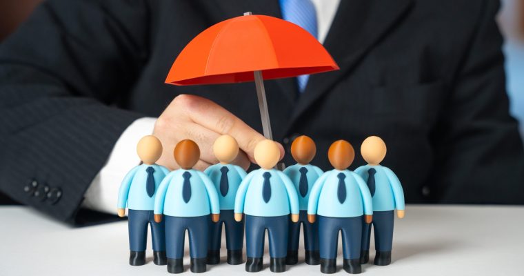A,Business,Leader,Holds,An,Umbrella,Of,Insurance,Over,His